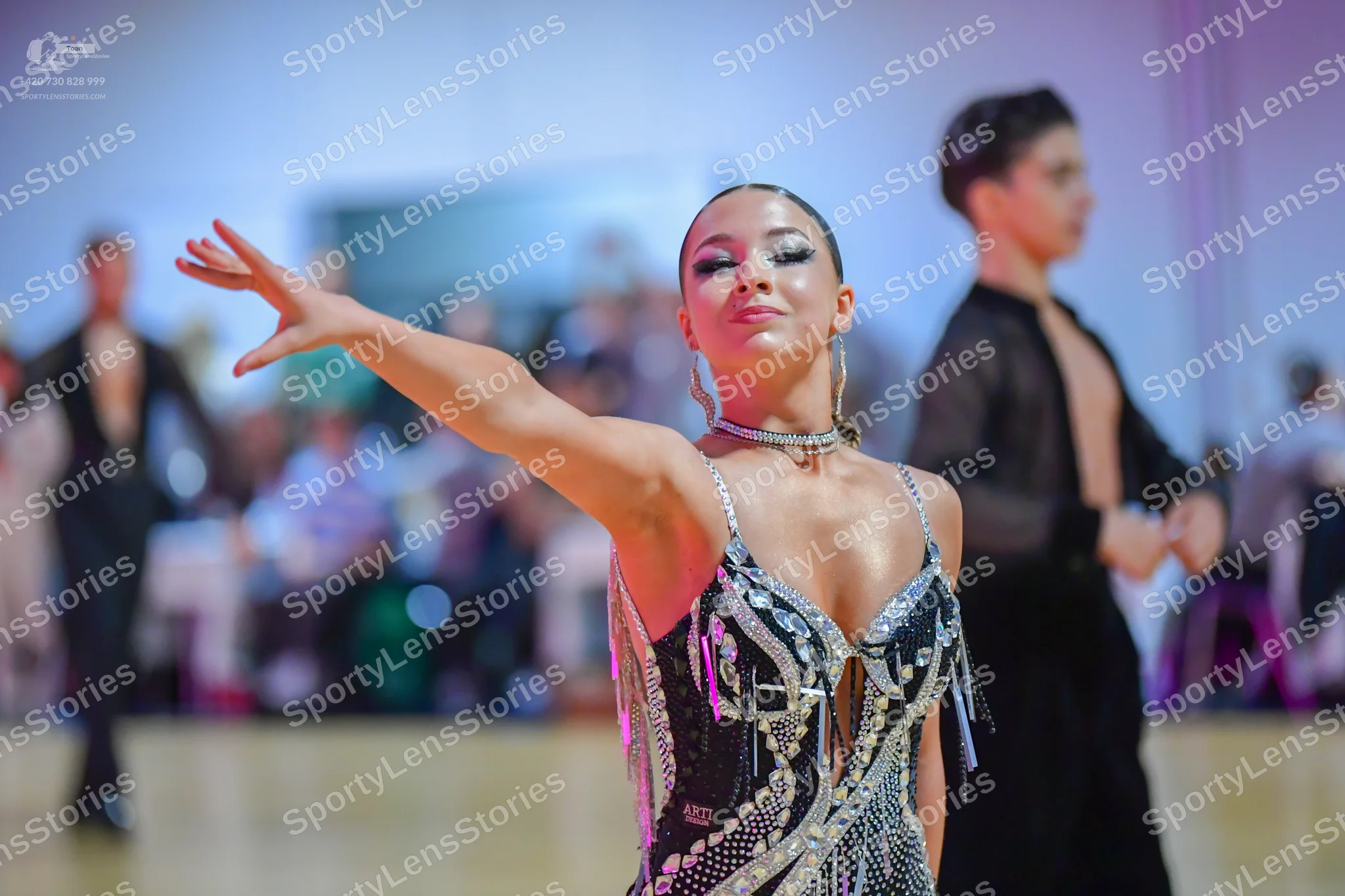 Dancesport competitor: Female dancer: black Latin dance dress decorated with silver sequins and rhinest