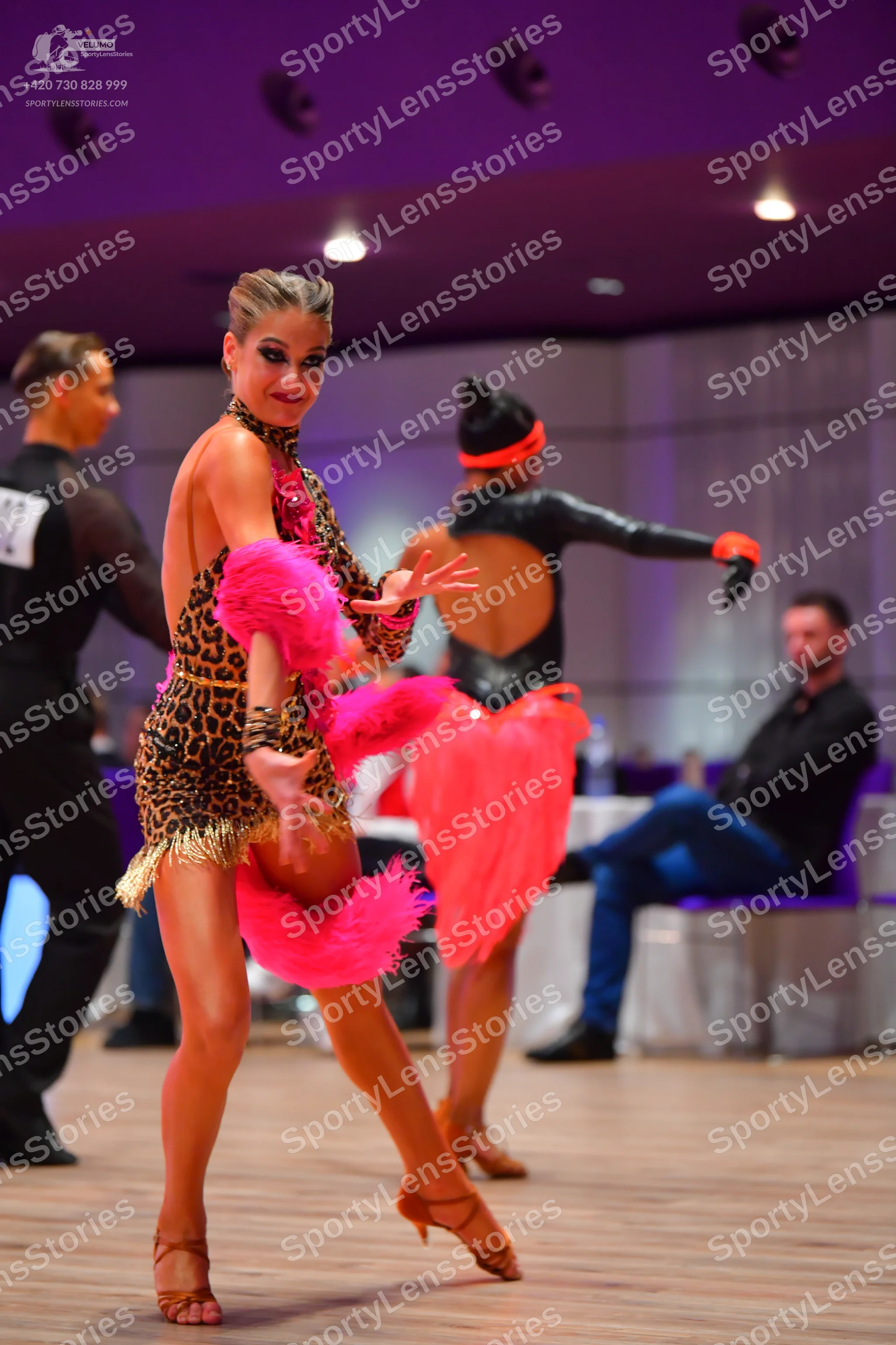 Dancesport competitor: Male dancer: black long-sleeved top with sheer sleeves and black trousers