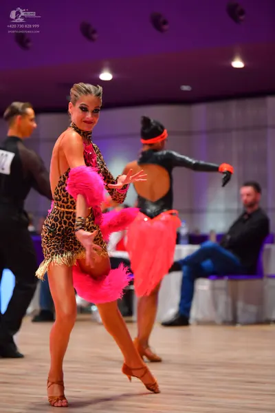 Dancesport competitor: Male dancer: black long-sleeved top with sheer sleeves and black trousers