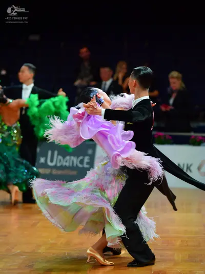 Dancesport competitor: Male dancer 1: black tuxedo with white shirt and white bow tie