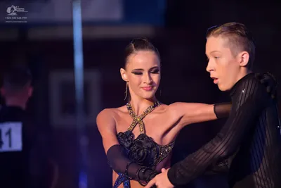 Dancesport competitor #41: Male dancer: black long-sleeved top with a vertical textured pattern