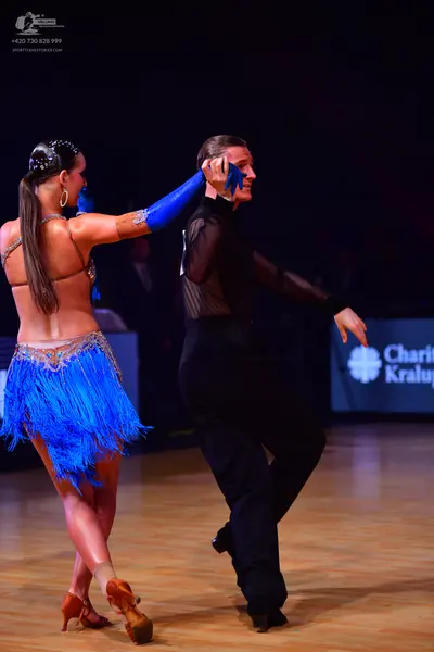 Dancesport competitor: Male dancer: black Latin dance shirt with mesh sleeves and black trousers