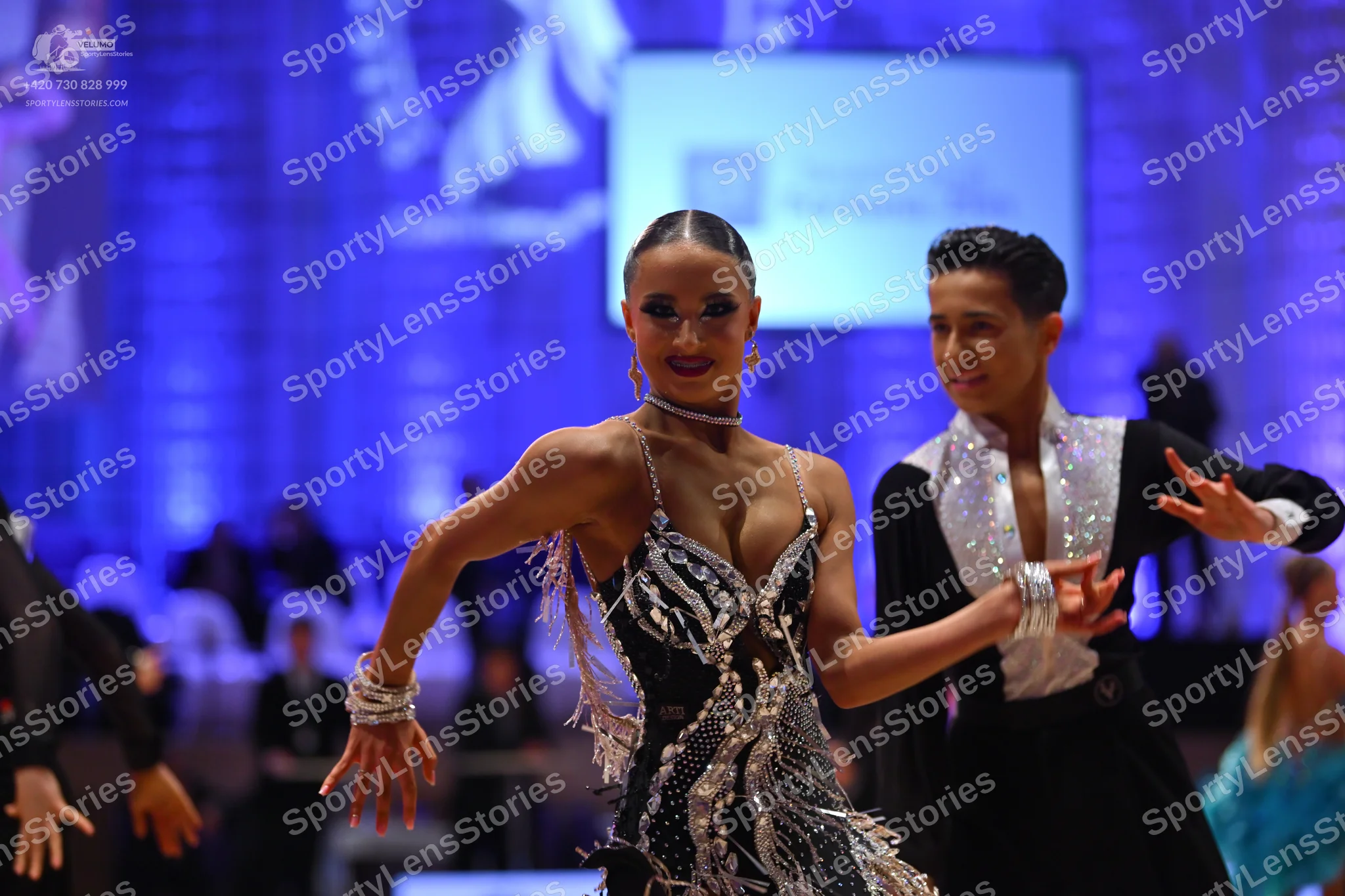 Dancesport competitor: Female dancer: black Latin dress with silver sequin embellishments and thin stra