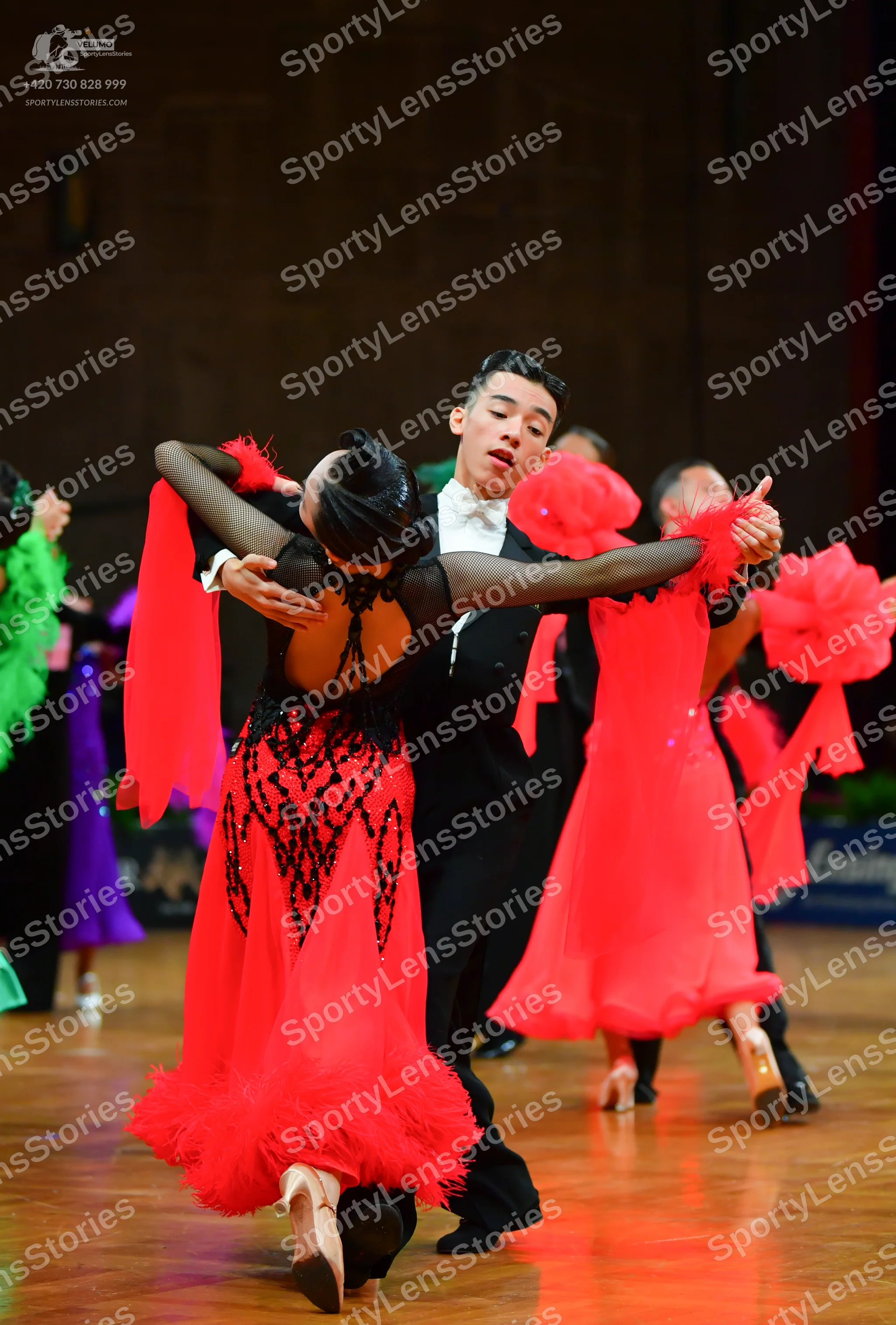 Dancesport competitor: Female dancer: red and black latin dress with a black sequined bodice and a red