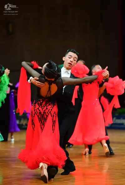 Dancesport competitor: Female dancer: red and black latin dress with a black sequined bodice and a red 