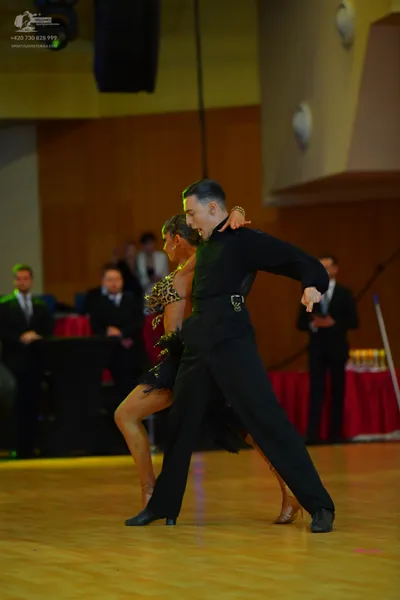 Dancesport competitor: Male dancer: black long-sleeved shirt and black trousers