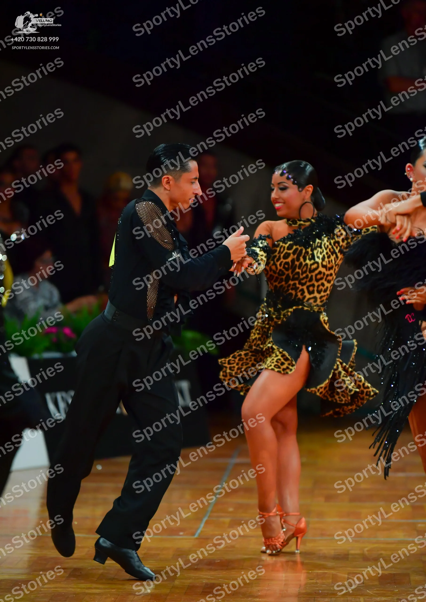 Dancesport competitor: Male dancer: black long-sleeved shirt with sequin embellishments on the shoulder