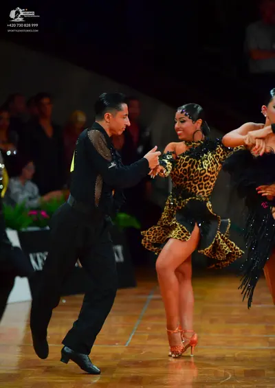 Dancesport competitor: Male dancer: black long-sleeved shirt with sequin embellishments on the shoulder