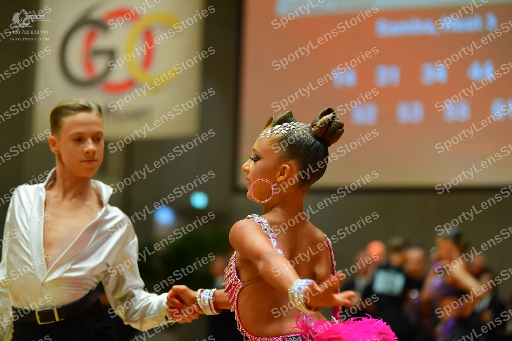 Dancesport competitor: Male dancer: white long-sleeved shirt and black trousers with a black belt