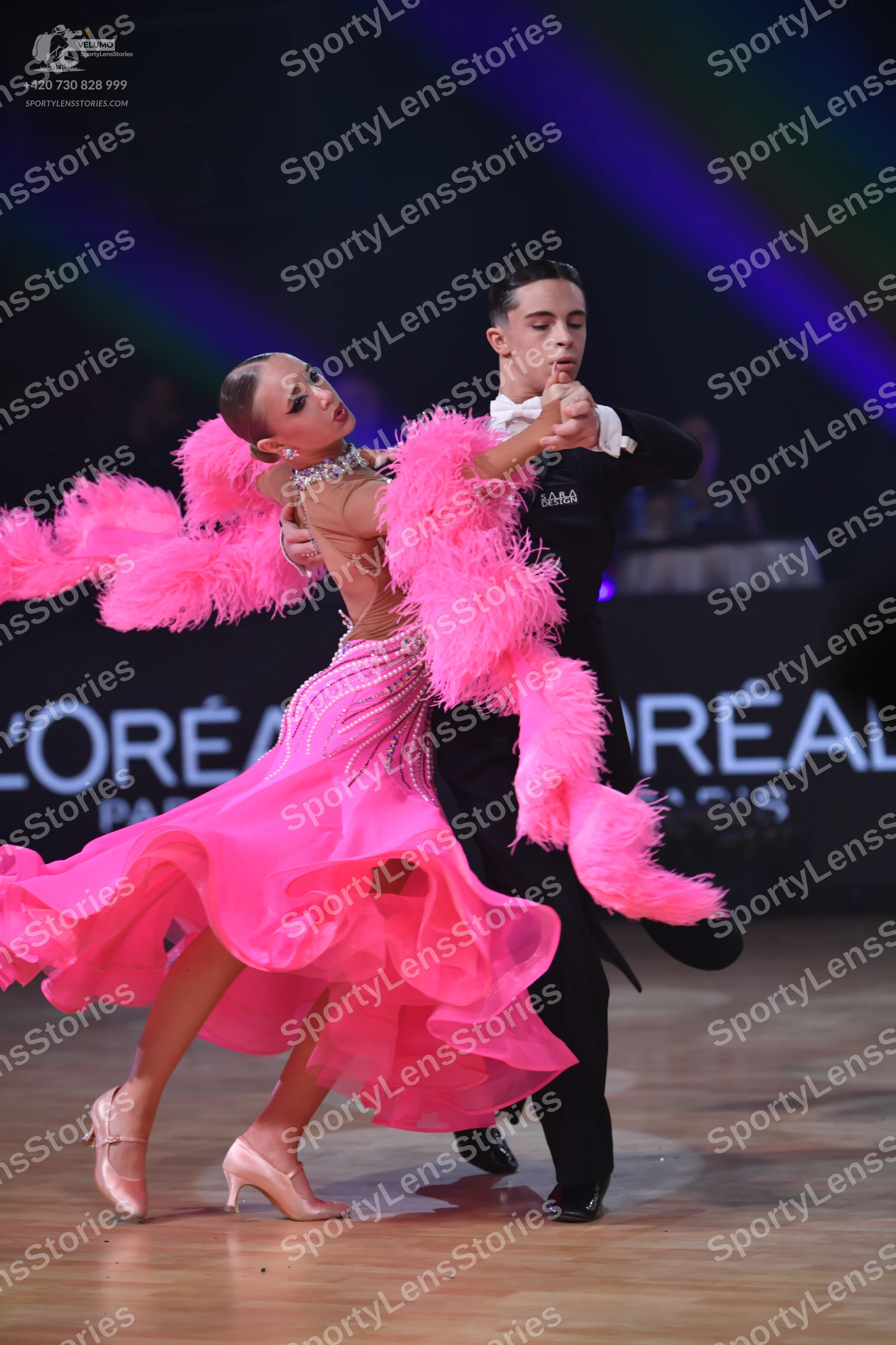 Dancesport competitor: Male dancer: black formal suit with a white shirt and white bow tie
