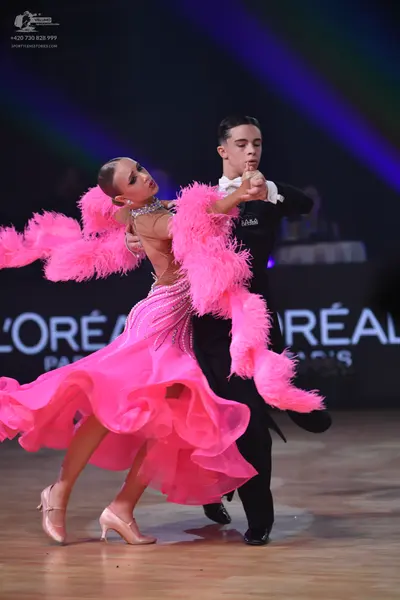 Dancesport competitor: Male dancer: black formal suit with a white shirt and white bow tie