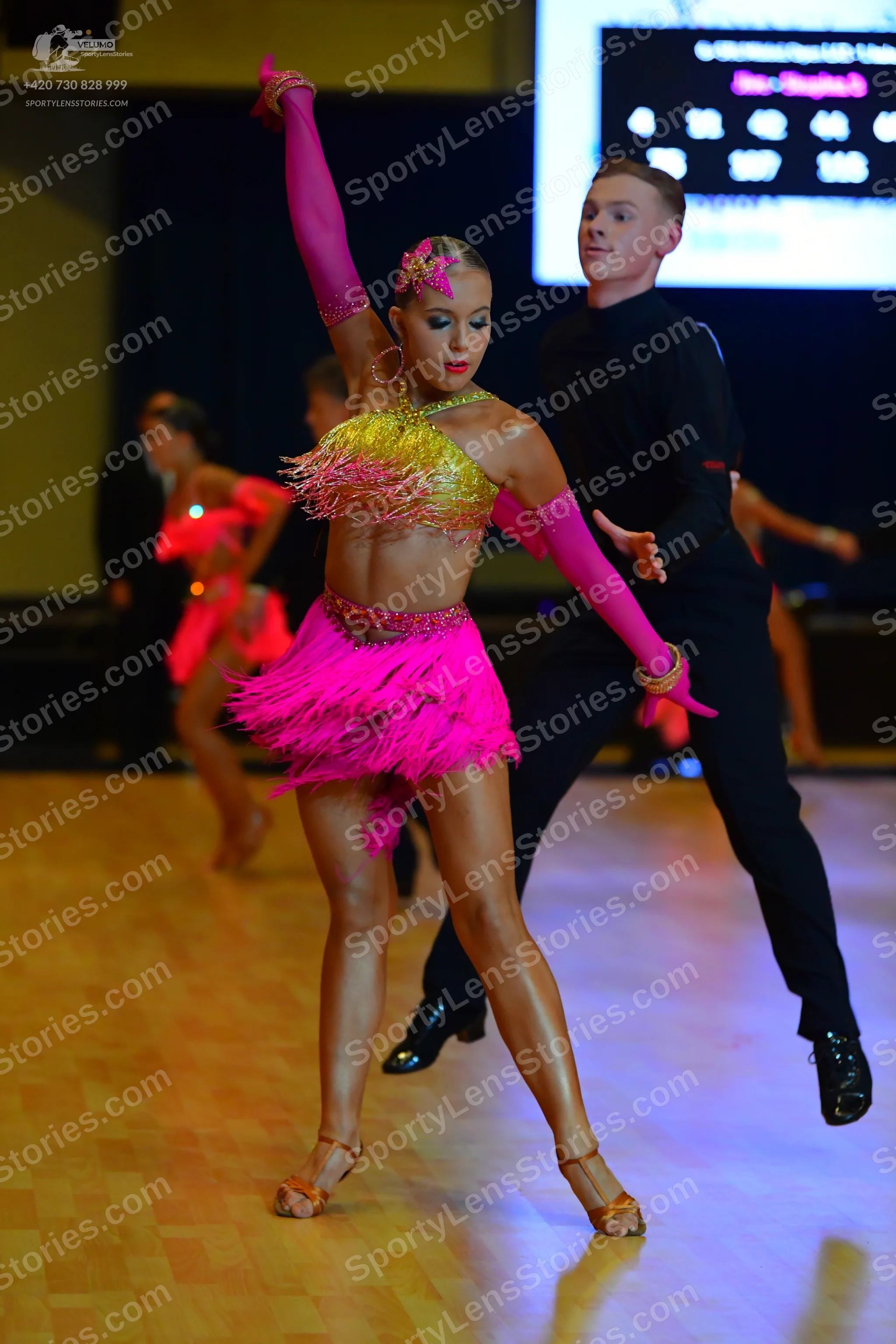 Dancesport competitor: Female dancer: pink and yellow Latin dance costume with a yellow sequined top, p