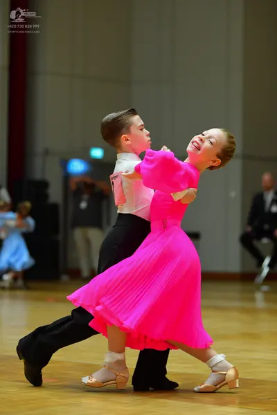 Dancesport competitor: Male dancer: white long-sleeved shirt and black trousers