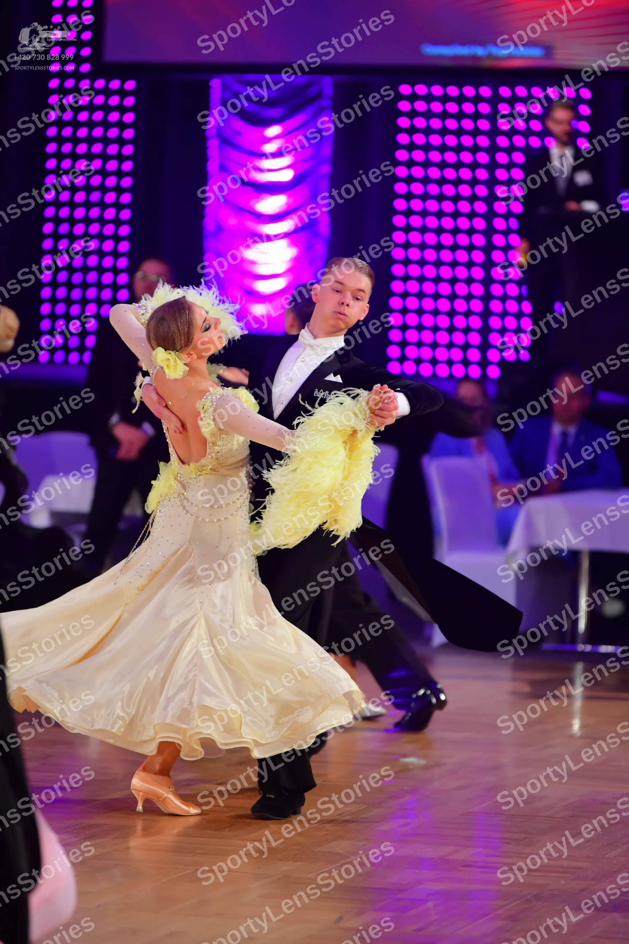 Dancesport competitor: Male dancer: black suit with a white shirt and white bow tie