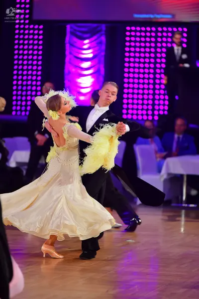 Dancesport competitor: Male dancer: black suit with a white shirt and white bow tie