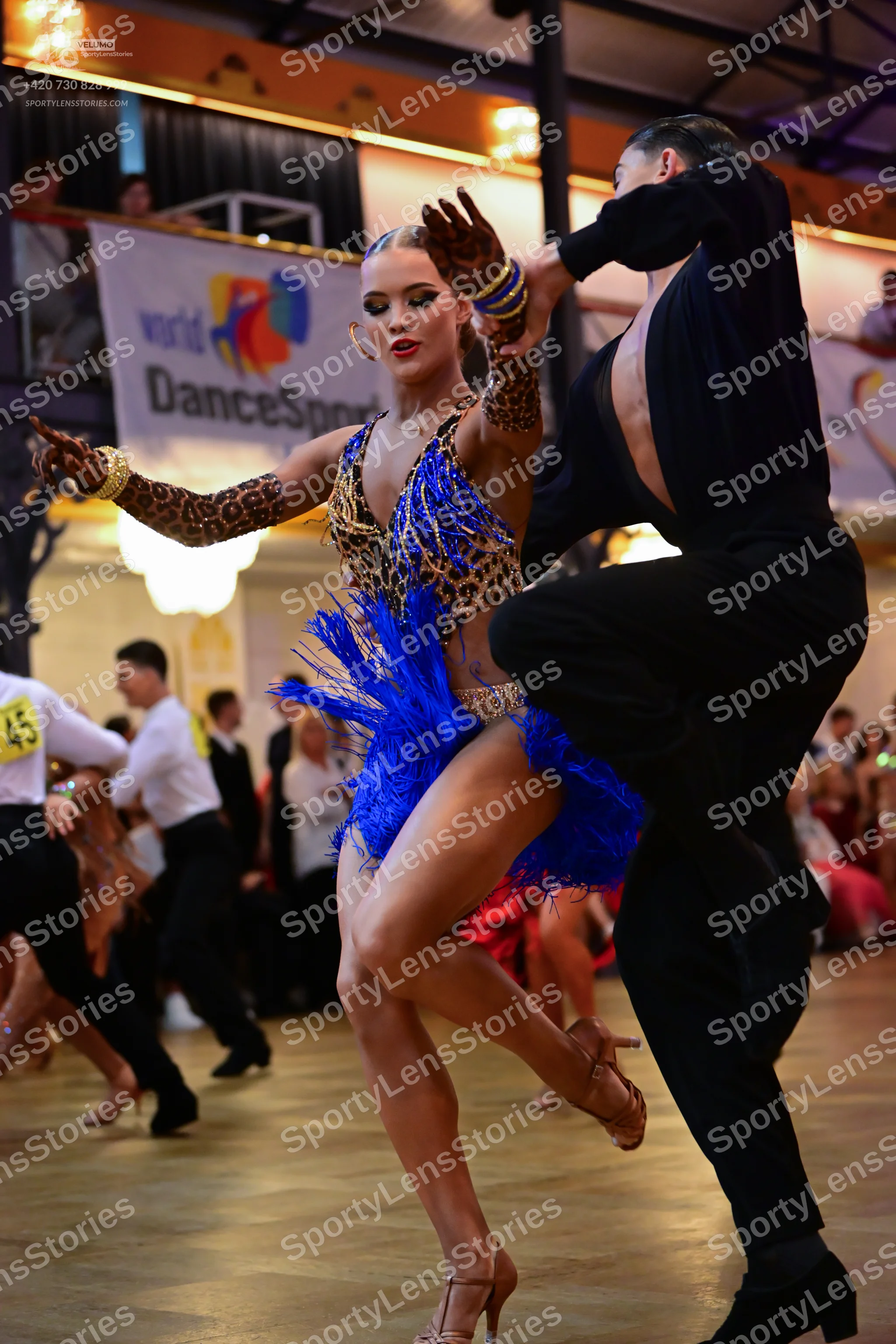 Dancesport competitor #45: Main female dancer: leopard print latin dress with bright blue fringe and matchi