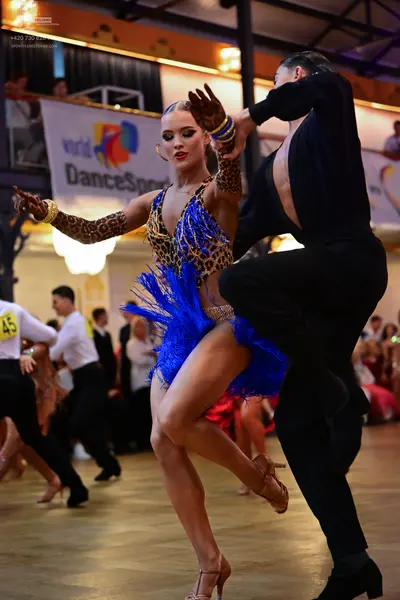 Dancesport competitor #45: Main female dancer: leopard print latin dress with bright blue fringe and matchi