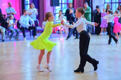 Dancesport competitor #311: Female dancer (foreground): lime green latin dress