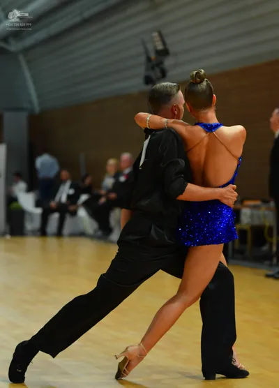 Dancesport competitor: Male**

*   **Color:** Dark blue/navy
*   **Fabric:** Sequins (primarily) with p