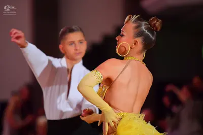 Dancesport competitor: Male dancer: white long-sleeved shirt and black trousers
