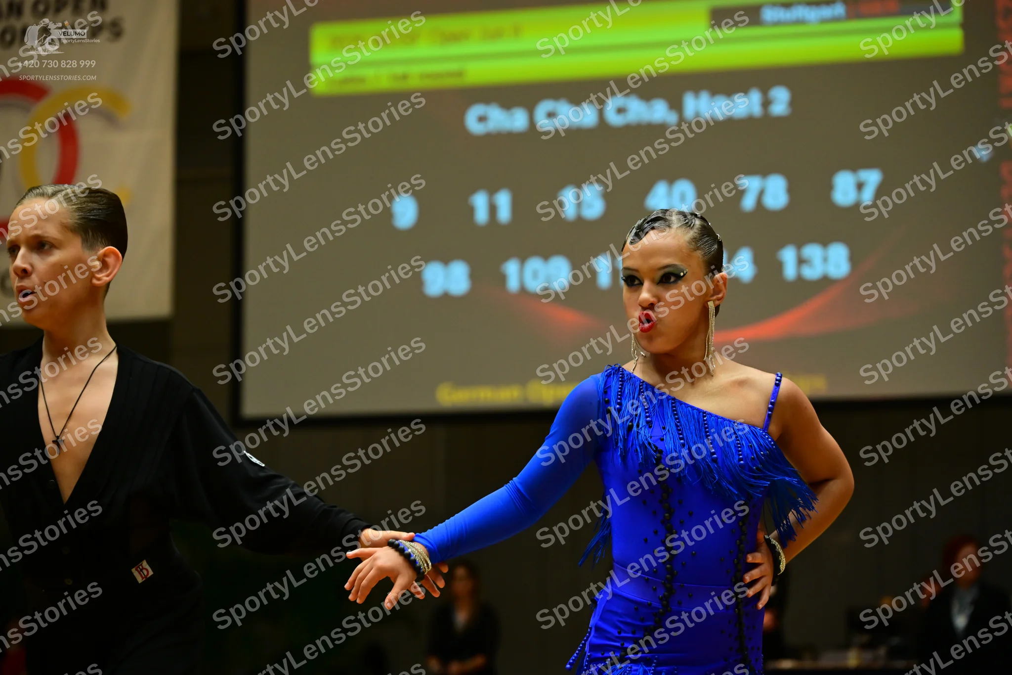 Dancesport competitor: Male dancer: black long-sleeved Latin dance top with a deep V-neck