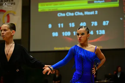 Dancesport competitor: Male dancer: black long-sleeved Latin dance top with a deep V-neck