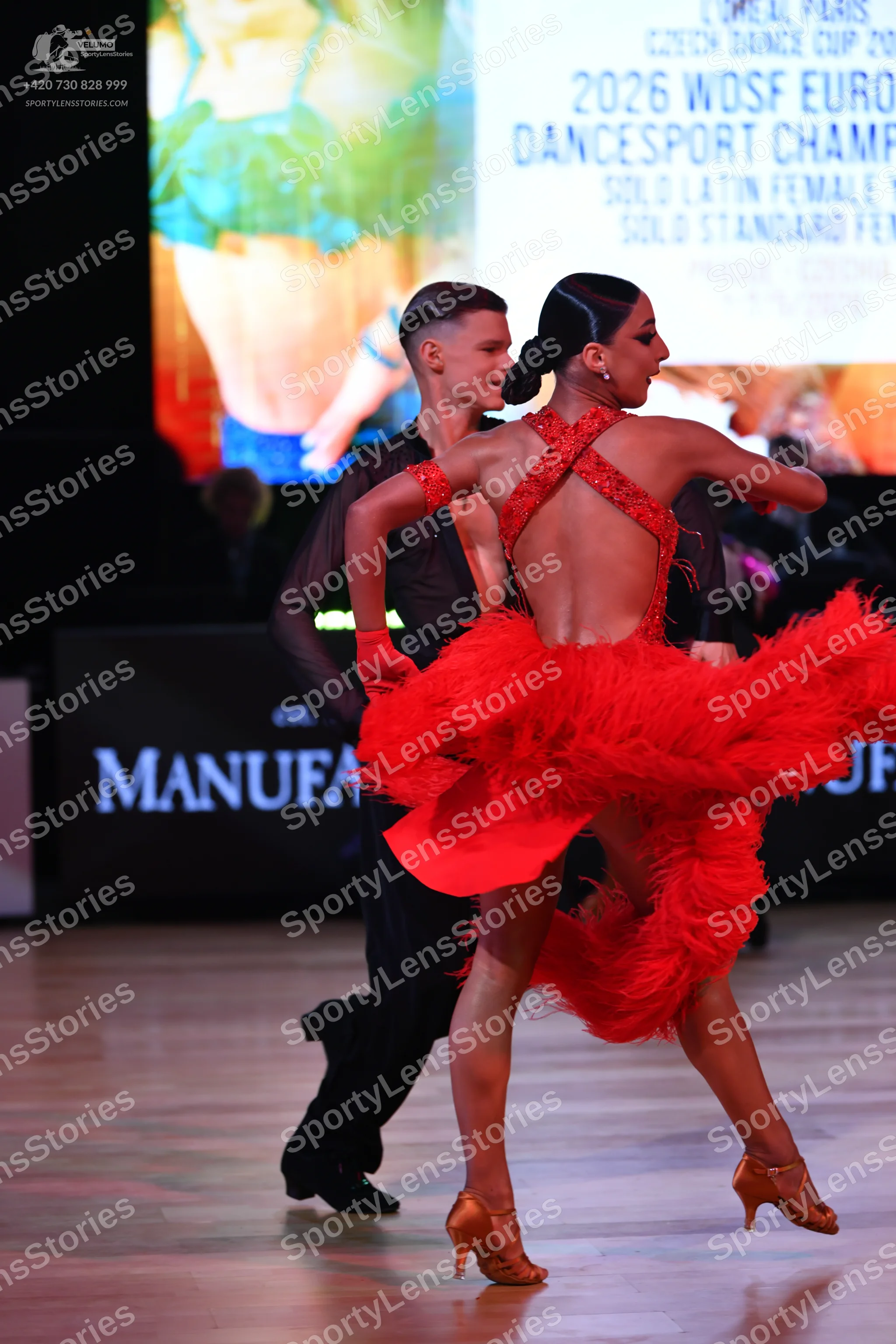 Dancesport competitor: Female dancer: red latin dress with a red sequined bodice and a large, voluminou
