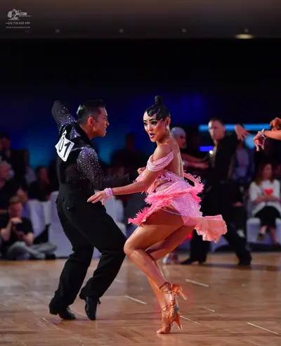 Dancesport competitor #01: Male dancer: black long-sleeved sequin top and black trousers
