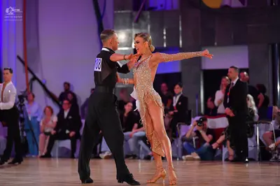 Dancesport competitor: Male dancer: black long-sleeved shirt and black trousers