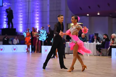 Dancesport competitor: Male dancer: black long-sleeved shirt and black trousers