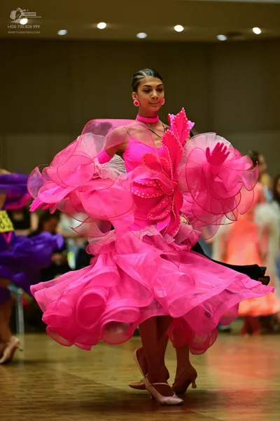 Dancesport competitor: ** Pink Ballgown
*   **Color:** Bright, vibrant pink 
*   **Fabric:** Appears to
