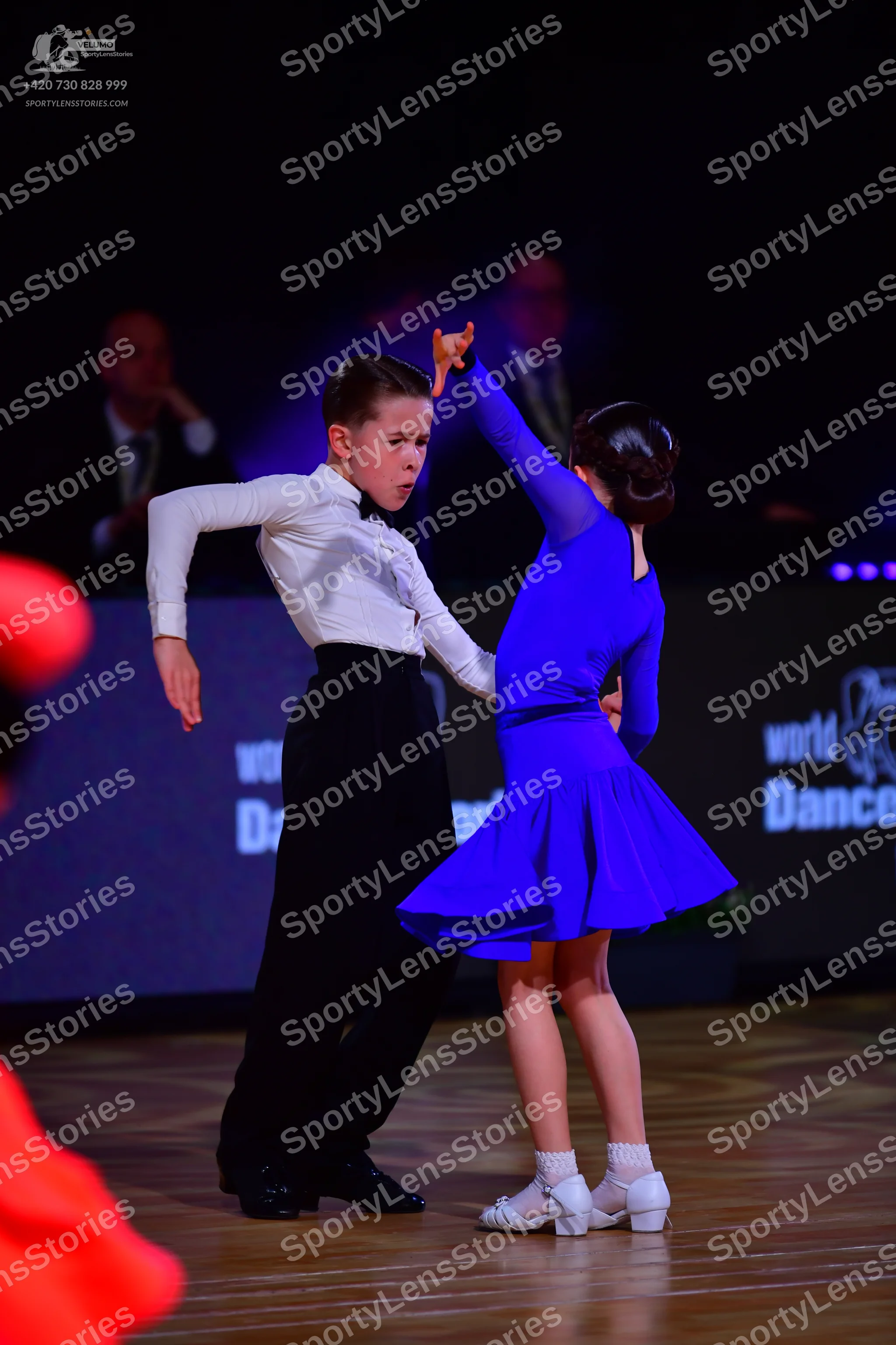 Dancesport competitor: Male dancer: white long-sleeved shirt, black trousers, and a black bowtie