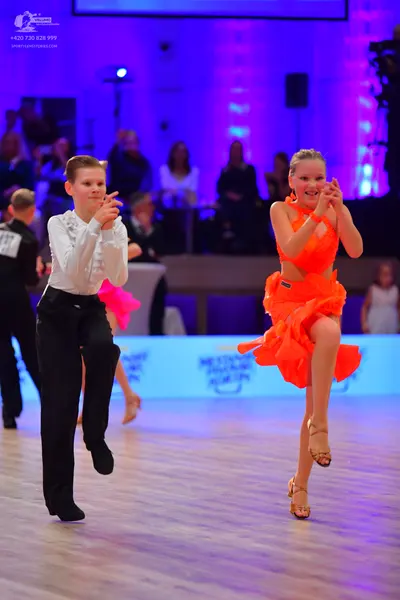 Dancesport competitor: Male dancer: white long-sleeved shirt and black trousers