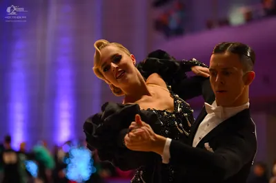 Dancesport competitor: Male dancer: black suit with a white shirt and white bowtie
