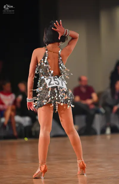 Dancesport competitor #257: Female dancer: black latin dress with silver sequins and hanging metallic paille