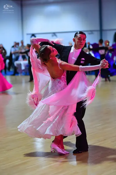 Dancesport competitor: Male dancer: black suit with a white shirt and black trousers
