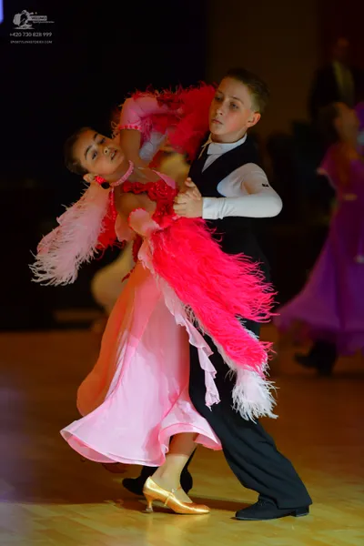 Dancesport competitor: Male dancer: black waistcoat, white long-sleeved shirt, and black trousers