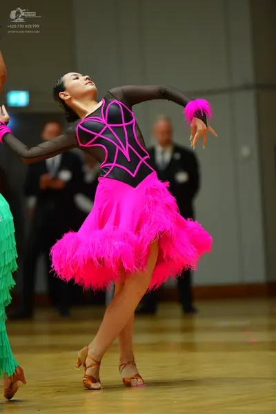 Dancesport competitor: Main female dancer: dark brown long-sleeved Latin dress with black graphic lines