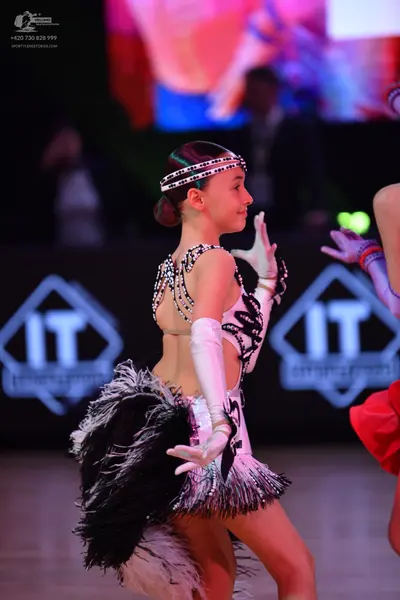 Dancesport competitor: Female dancer: black and white latin dance costume with white sequin patterns, w