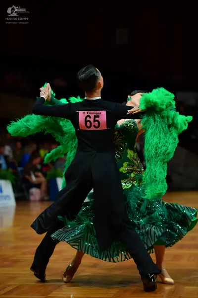 Dancesport competitor: Male dancer: black long-sleeved shirt and trousers