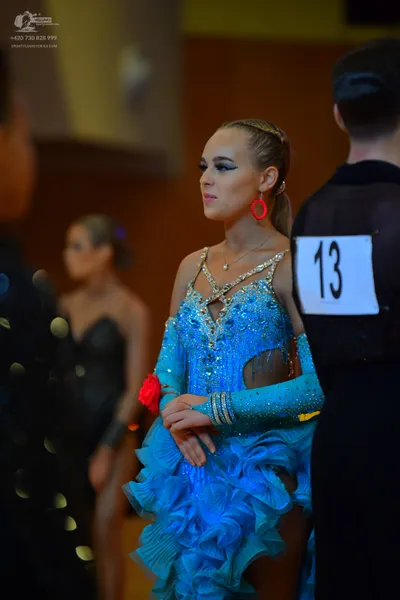 Dancesport competitor #13: Female dancer: light blue latin dress with sequins, fringe, and ruffles