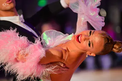 Dancesport competitor: Male dancer: black suit with a white shirt and white bow tie