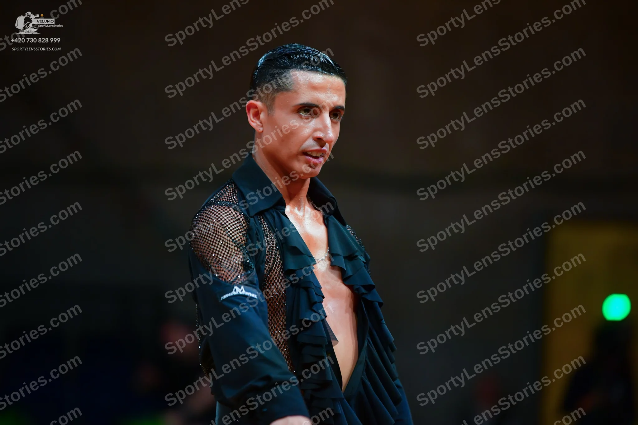 Dancesport competitor: Male dancer: black Latin dance shirt with ruffled front and mesh sleeve