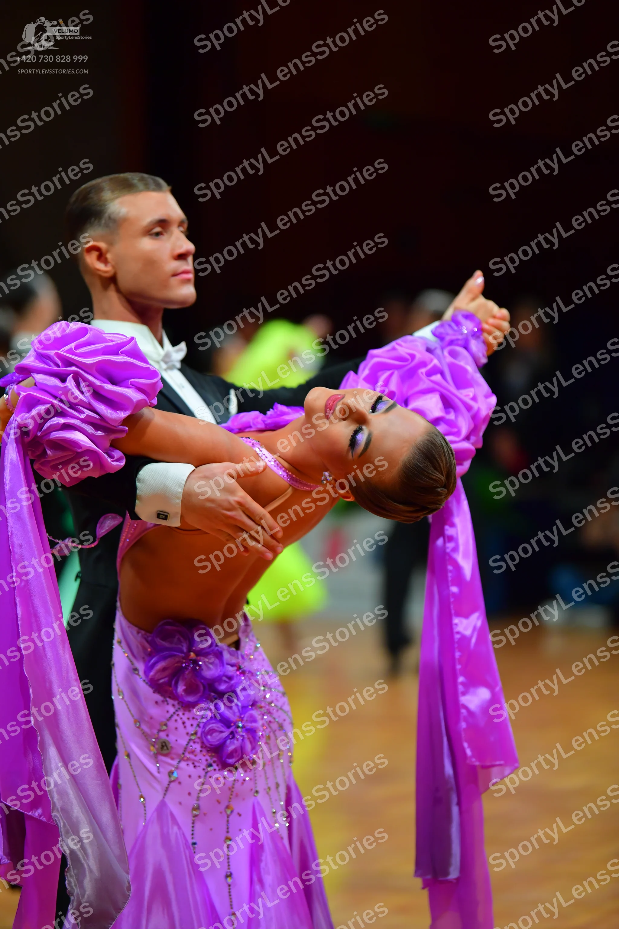 Dancesport competitor: Male dancer: black suit with a white shirt and white bow tie