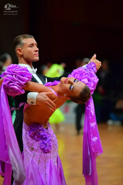 Dancesport competitor: Male dancer: black suit with a white shirt and white bow tie