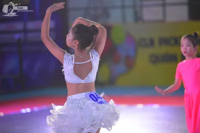 Dancesport competitor: ** White, iridescent, cropped, short sequin dress with a sweetheart neckline and