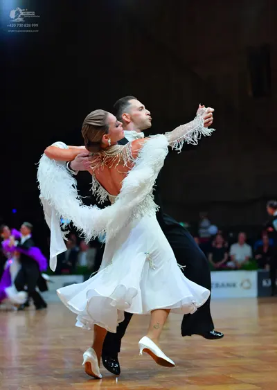 Dancesport competitor: Female dancer: white ballroom gown with voluminous white fringe-like texture on 