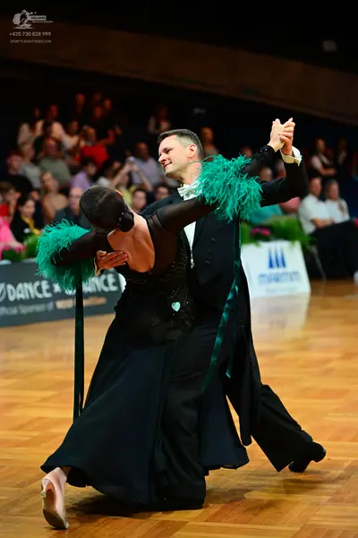 Dancesport competitor: Male dancer: black suit with a white shirt and white bow tie