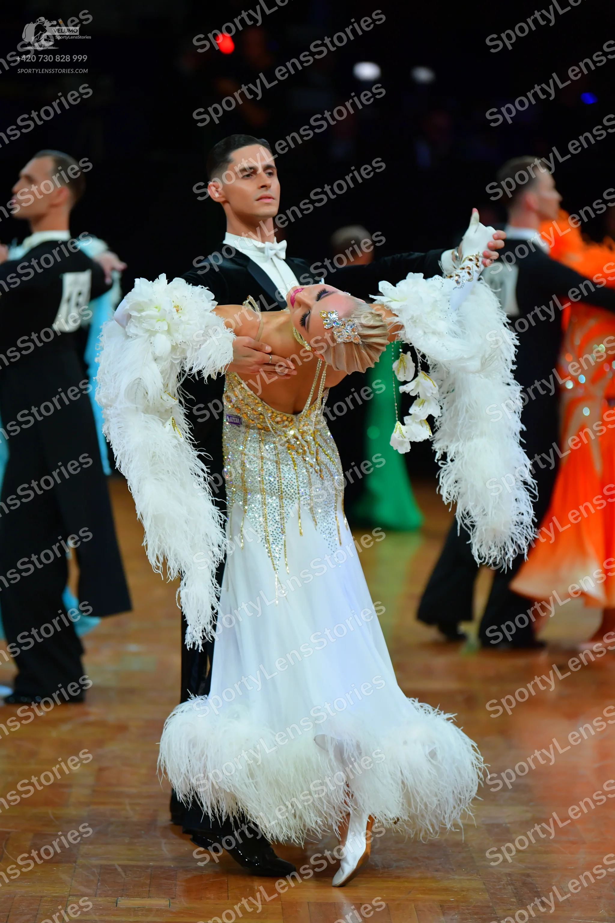 Dancesport competitor #13: Male dancer: black suit with white shirt and white bow tie