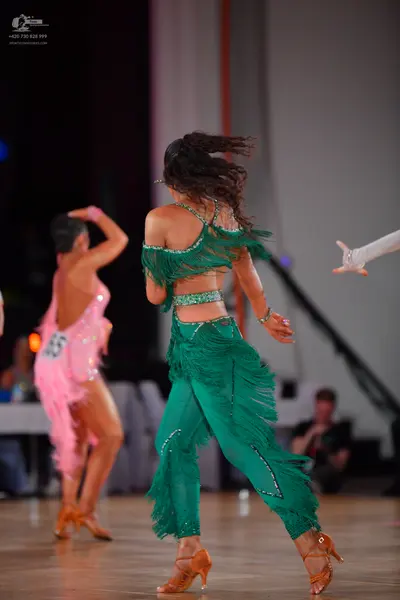 Dancesport competitor: Female dancer: pink Latin dance costume with sequins and fringe